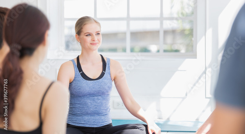 Free Download Portrait of Caucasian instructor woman sitting and talking with group of sporty student in yoga class at fitness studio. healthy wellness people activity at health club - GFXLoad