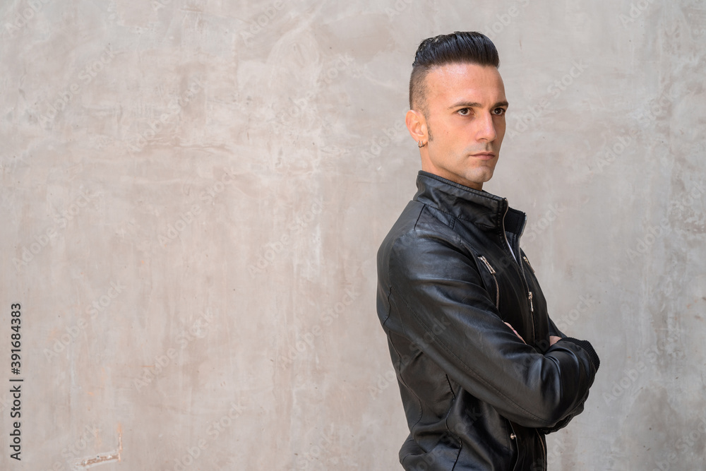 Handsome young Italian man with undercut wearing black leather jacket