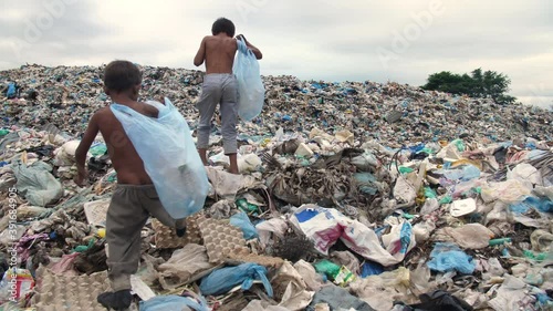 Poor Children Walking On Garbage Dump
 photo