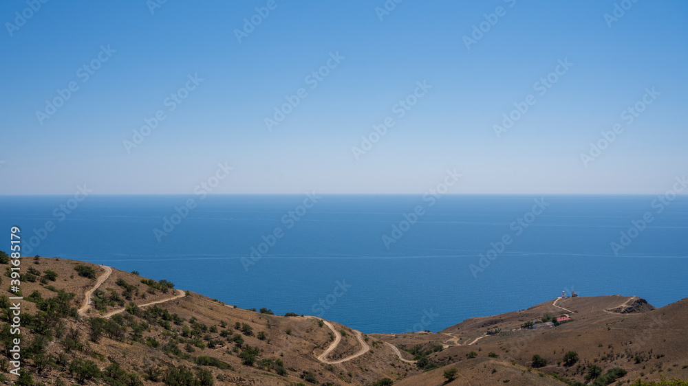 road leading to the coast and the lighthouse, sea view road leading to the coast and the lighthouse, sea view
