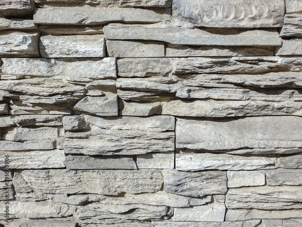 Abstract background wall covered with stone. Stone wall background brown. Decorative stone on the wall. Selective focus