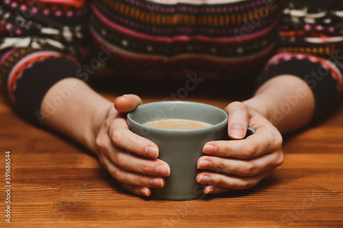 Young woman drinking hot cocoa or coffee. Autumn or winter moody weekend, New Year and Christmas background. Lazy day, quarantine, stay home, cosy scene, hygge concept.