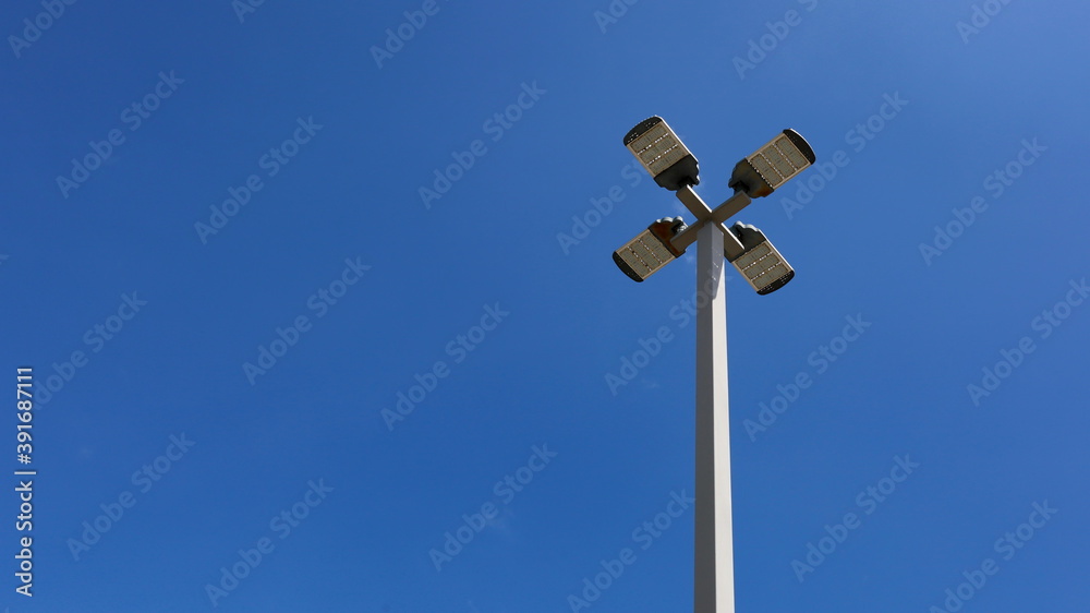 Modern LED lamp on metal pillar. Tall LED public street lights use solar energy which is an energy saving technology On a blue sky background and Copy space. Close focus and select an object