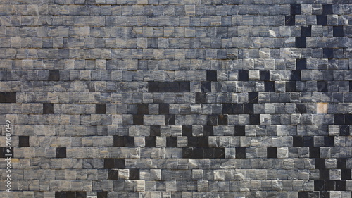 Fototapeta Naklejka Na Ścianę i Meble -  Small gray granite wall in square shape. Modern style stone wall background and texture design decorated with stone lined. Selective focus