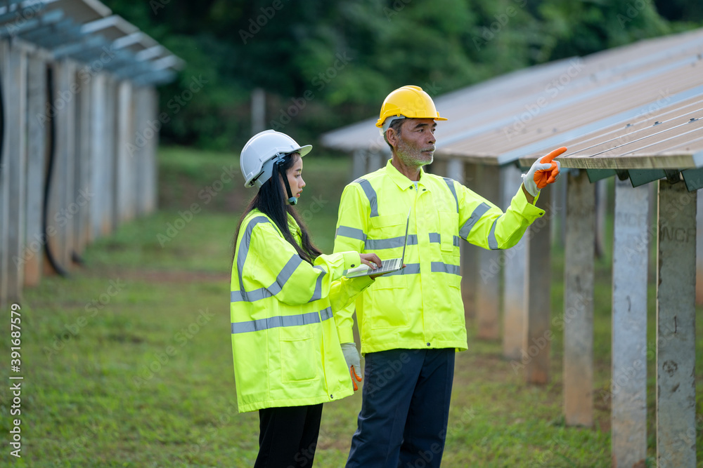 Solar power plant,Engineer working with tablet computer at Solar Panels Power Farm,Science solar energy,Photovoltaic Cell Park. Solar power plant,Engineer working with tablet computer at Solar Panels Power Farm,Science solar energy,Photovoltaic Cell Park.