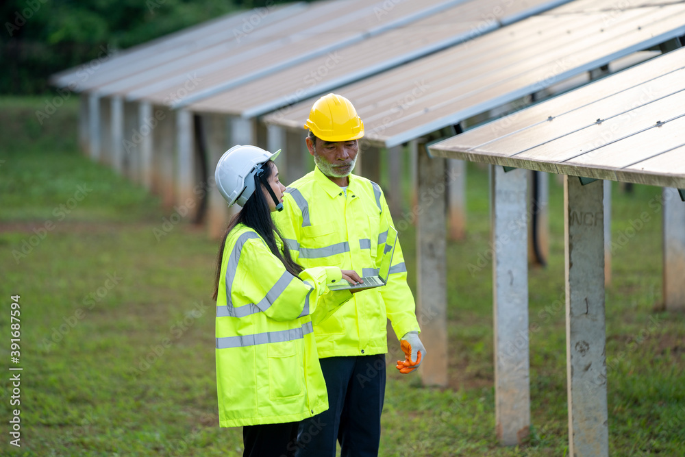 Engineer Woman Holding Digital Tablet Working Technician in Solar Panels Power Farm,Green Energy Concept. Engineer Woman Holding Digital Tablet Working Technician in Solar Panels Power Farm,Green Energy Concept.
