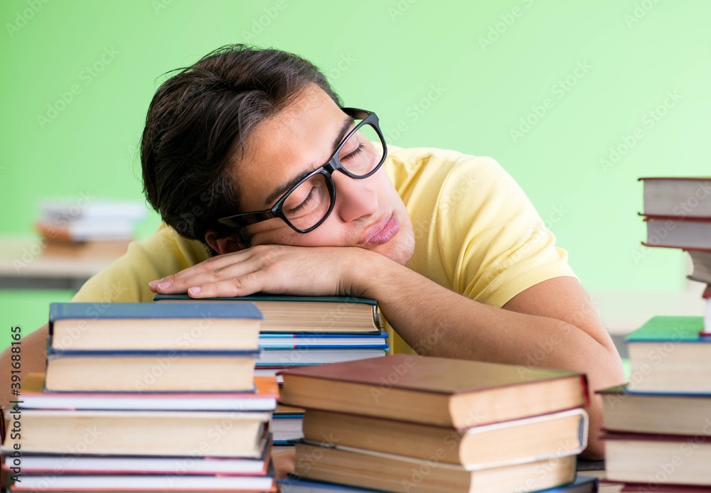 Student with too many books to read before exam Student with too many books to read before exam