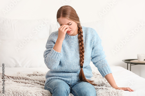 Stressed young woman at home