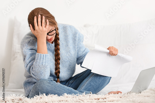 Stressed young woman workin...