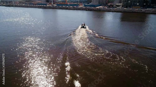 Aerial view of a boat in Kalasatama, sunny day, in Helsinki, Finland - dolly, drone shot photo