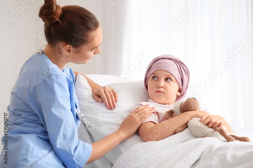 Nurse and little girl under...