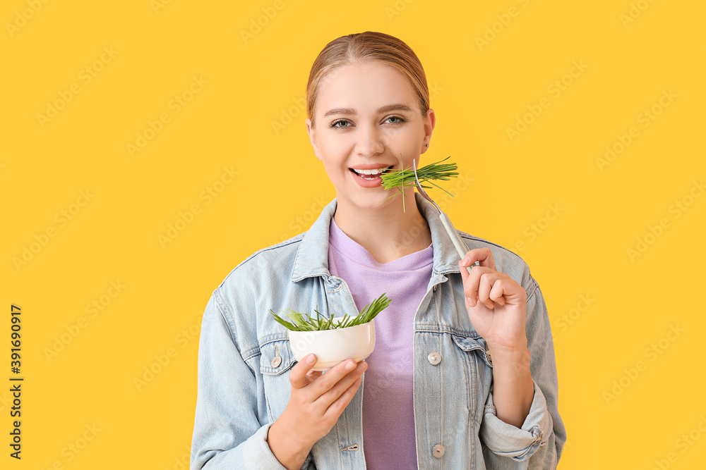 Young woman eating wheatgrass on color background Young woman eating wheatgrass on color background
