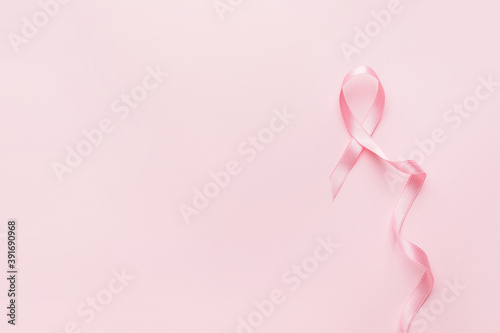 Pink ribbon on color background. Breast cancer awareness concept