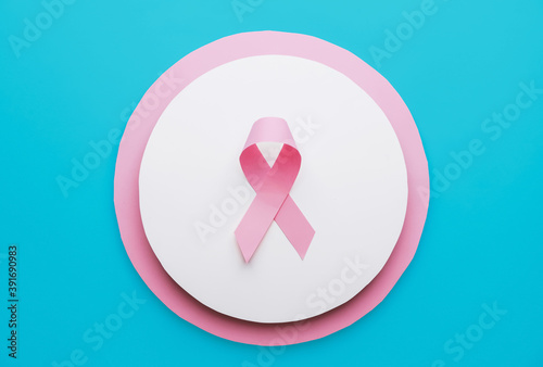 Pink ribbon on color background. Breast cancer awareness concept