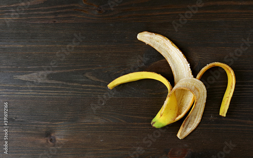 Banana Skin Isolated on Wooden Background for the Concept of the BENEFITS OF BANANA SKIN