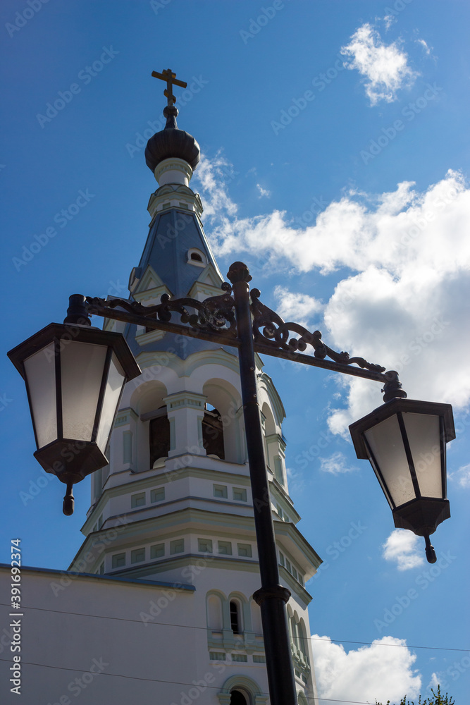 A street lamp and a tent-roofed bell tower of the Russian Orthodox Church in the background. Borovsk, Russia
