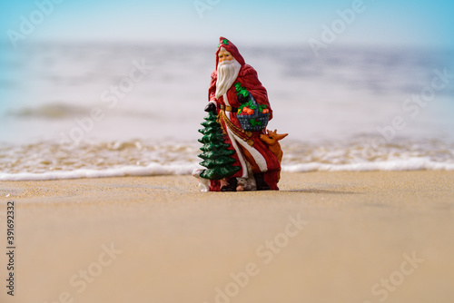 Christmas greeting cards design. Santa Claus on sea beach. Happy New Year and merry Christmas travel, tropical vacations concept.