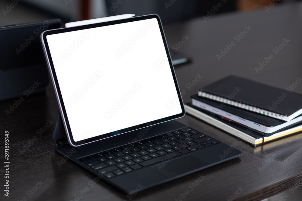 Mock up. blank screen digital tablet with office supplies on black wooden table. Mock up. blank screen digital tablet with office supplies on black wooden table.