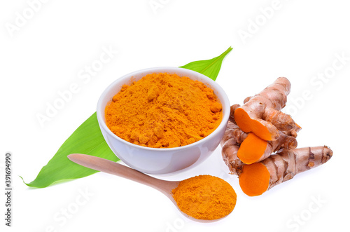 Turmeric roots and turmeric powder on white background