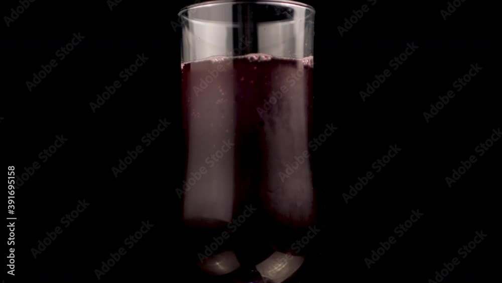 Blueberry Juice in Glass, Close Up Spinning, Isolated on Black Background Blueberry Juice in Glass, Close Up Spinning, Isolated on Black Background