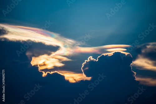 Beautiful iridescent cloud, Irisation or rainbow cloud on sky photo