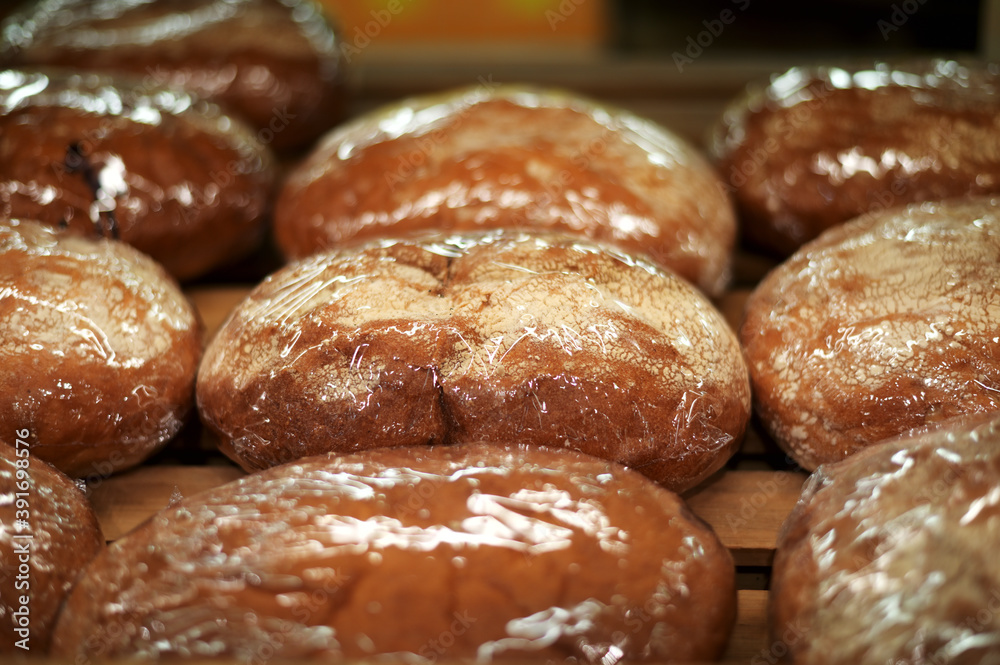 Photo of bun baked goods on the counter in a grocery store Photo of bun baked goods on the counter in a grocery store