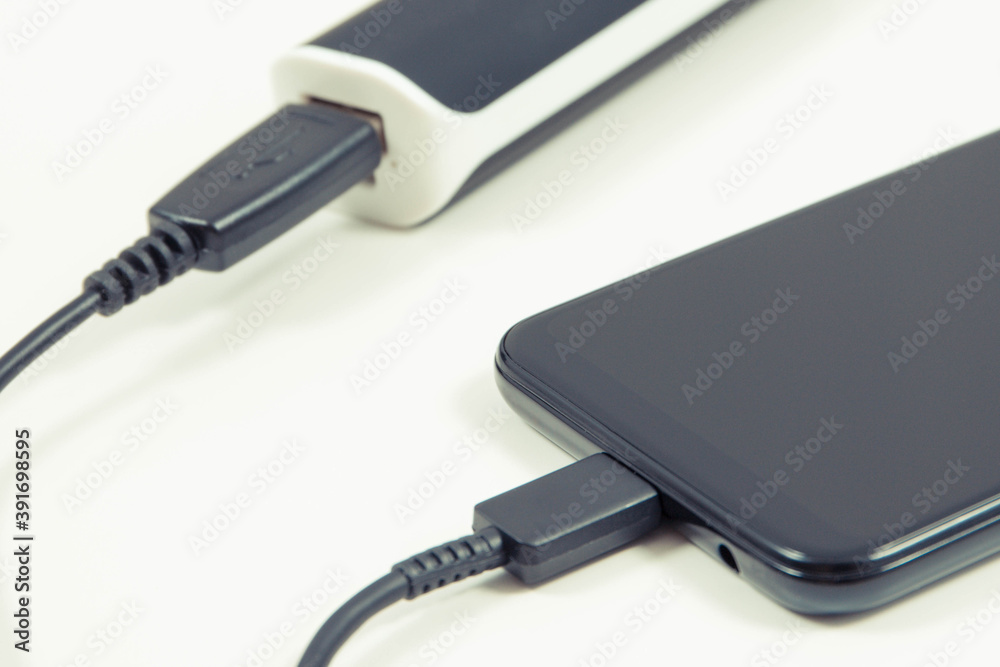 External powerbank charging empty battery of smartphone or mobile phone External powerbank charging empty battery of smartphone or mobile phone