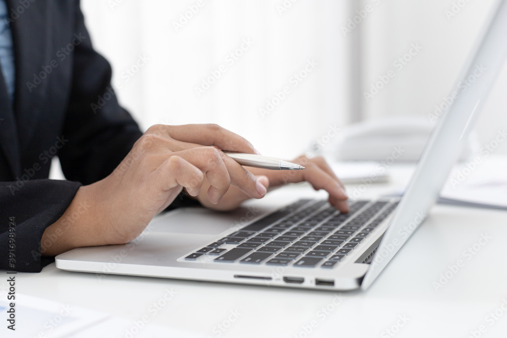 Financial businesswomen use laptop to analyze marketing strategies and real estate data to reduce company taxes for their customers, Accounting and Tax concept. Financial businesswomen use laptop to analyze marketing strategies and real estate data to reduce company taxes for their customers, Accounting and Tax concept.