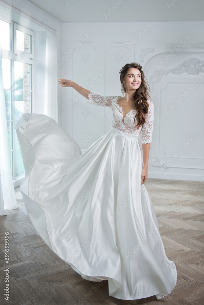 Portrait of a young bride in a fashionable wedding dress with beautiful makeup and hairstyle Portrait of a young bride in a fashionable wedding dress with beautiful makeup and hairstyle