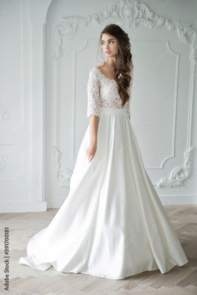 Portrait of a young bride in a fashionable wedding dress with beautiful makeup and hairstyle Portrait of a young bride in a fashionable wedding dress with beautiful makeup and hairstyle