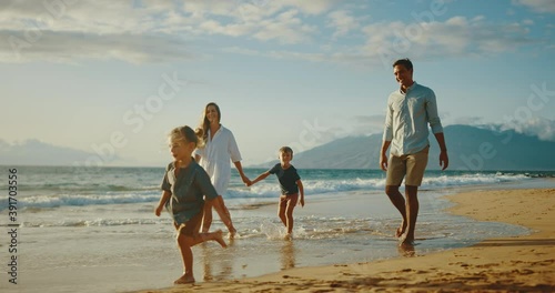 Happy young family playing at the beach on vacation