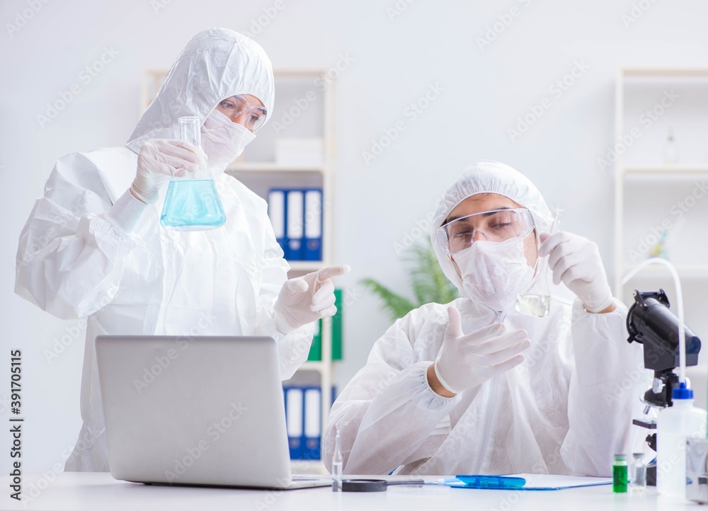 Two scientists working in the chemical lab Two scientists working in the chemical lab