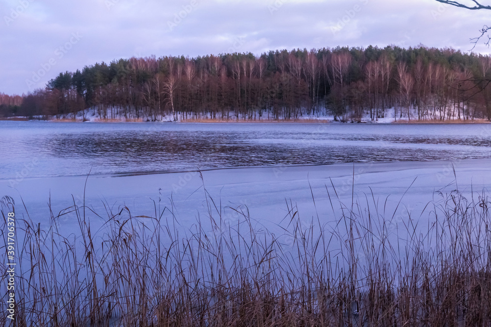Beautiful winter landscape with lake in Trakai, Lithuania in evening time.