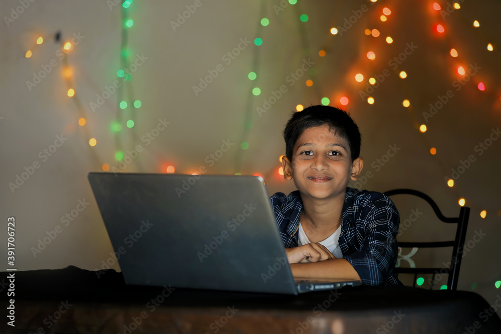 Cute indian little child using laptop at home Cute indian little child using laptop at home