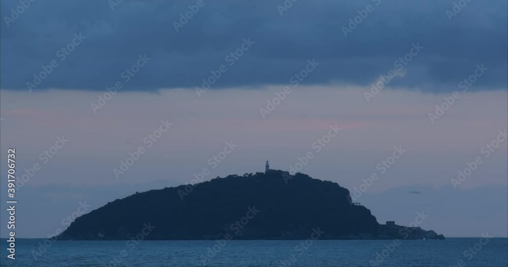 Timelapse Sky and sea with lighthouse of the Tino island. The clouds flow quickly in the sky and the lighthouse on the island emits flashes of light. Video footage royalty free. La Spezia, Italy. Abou Timelapse Sky and sea with lighthouse of the Tino island. The clouds flow quickly in the sky and the lighthouse on the island emits flashes of light. Video footage royalty free. La Spezia, Italy. Abou