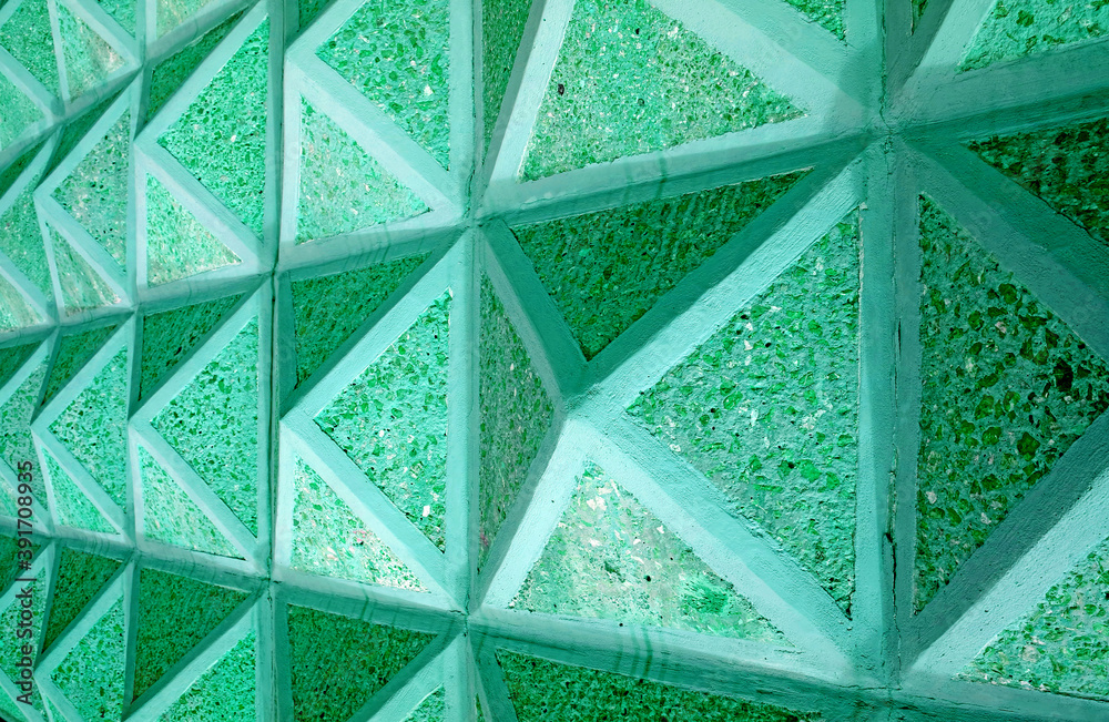 Pop art style neo mint green colored geometric 3d pattern concrete wall