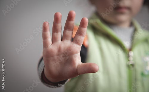 Caucasian little girl making stop gesture.