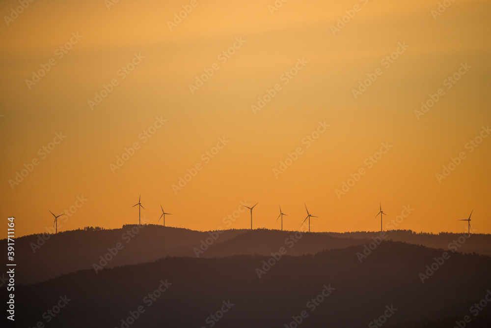 Wind power stations - wind turbines on the horizon, in the mountains, sky