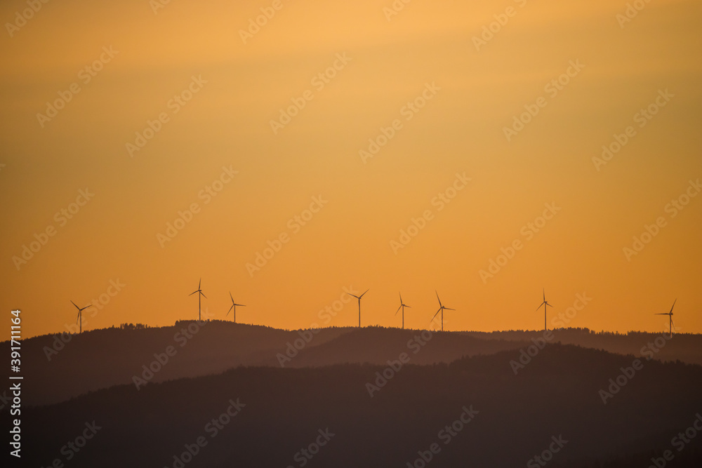 Wind power stations - wind turbines on the horizon, in the mountains, sky Wind power stations - wind turbines on the horizon, in the mountains, sky