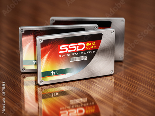 Generic SSDs standing on wooden table. 3D illustration