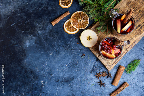 Christmas mulled wine. Holiday concept decorated with Fir branches, Cranberries and Spices.