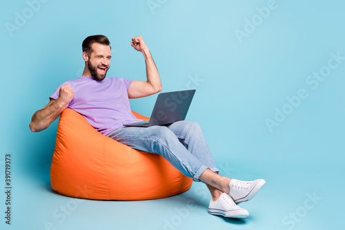 Full length body size photo of bearded freelancer gesturing like winner laptop isolated on vibrant blue color background photo
