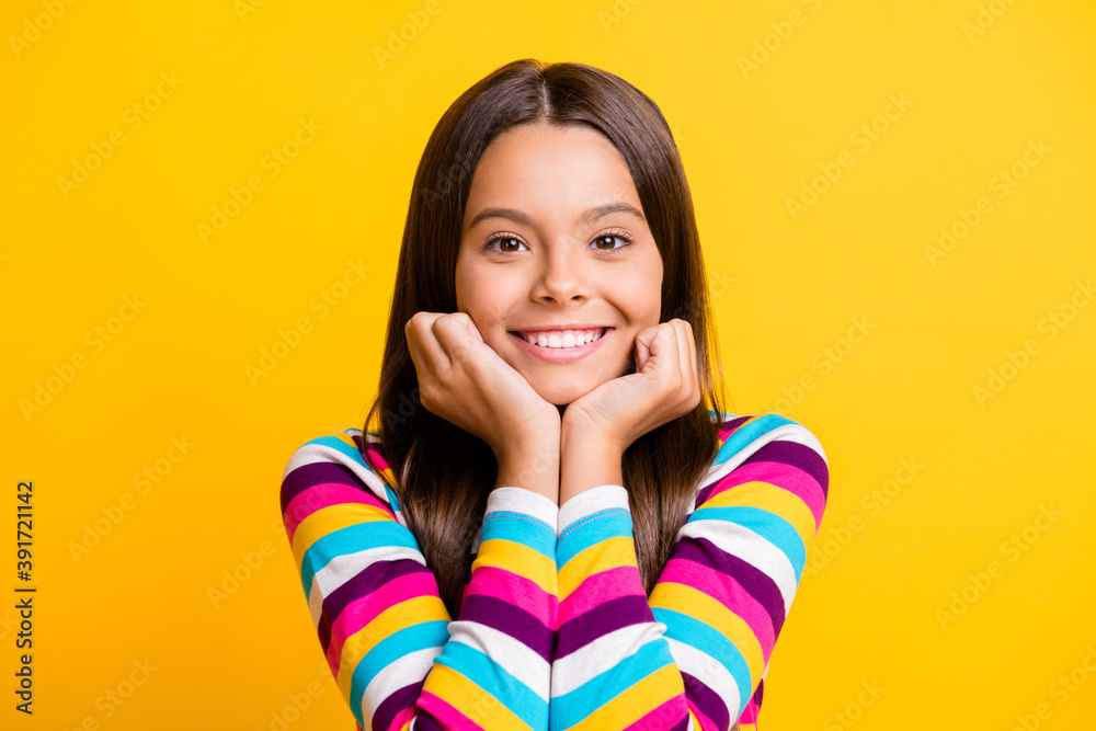 Photo of small girl two arms face cheeks toothy beaming smiling wear striped shirt isolated yellow color background Photo of small girl two arms face cheeks toothy beaming smiling wear striped shirt isolated yellow color background