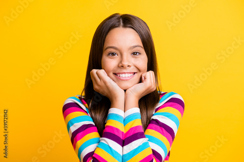 Photo of small girl two arms face cheeks toothy beaming smiling wear striped shirt isolated yellow color background