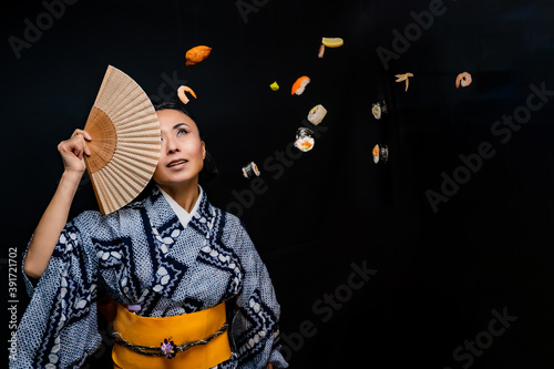Japanese Kimono Model holding fan over eyes