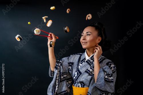 Japaense Kimono model eating sushi with chopstick