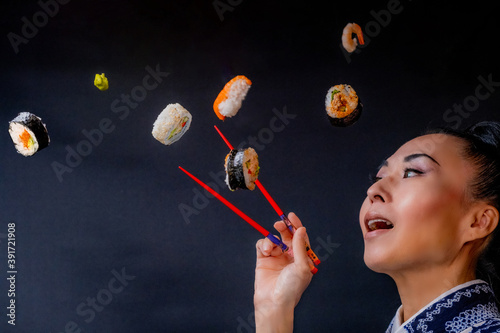 Japaense Kimono model eating sushi with chopstick