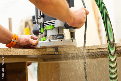 Electric milling cutter in the hands of a worker