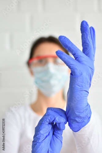 girl in medical mask and gloves. Photo sianto with selective focus