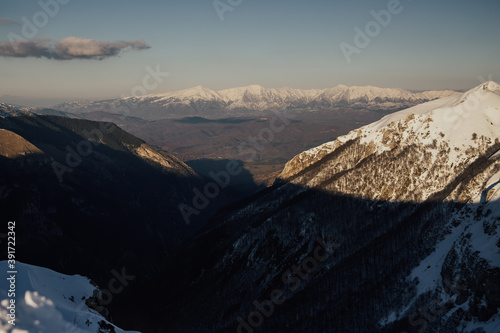 Mountains peak with snow with blue cloudy sky. Fantastic winter landscape.  Beautiful world. © eduard